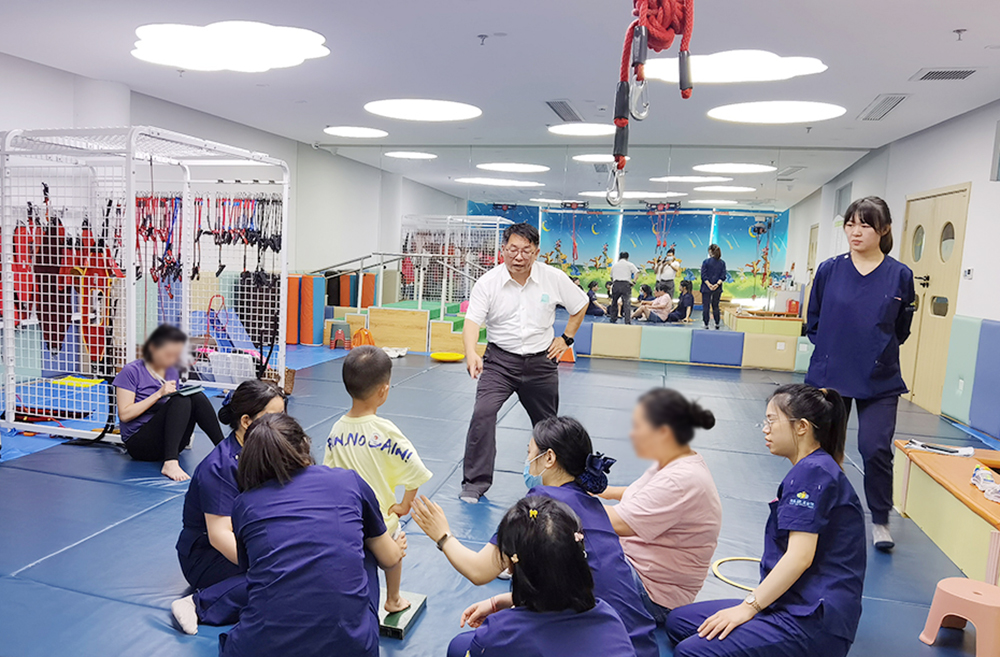 家长在康复师傅指导下学习康复技术.jpg